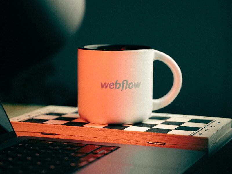 a coffee mug sitting on top of a laptop computer